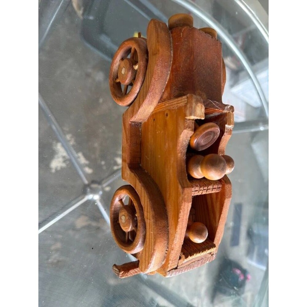 handcrafted wooden toy car in a vintage folk-art style